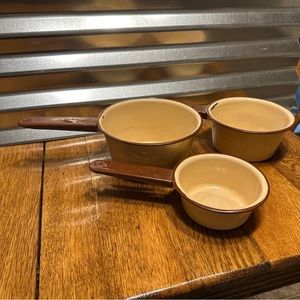 Vintage tan with brown handles enamel ware pots. Three different sizes.
